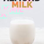 Side shot of a glass of almond milk with the words almond milk