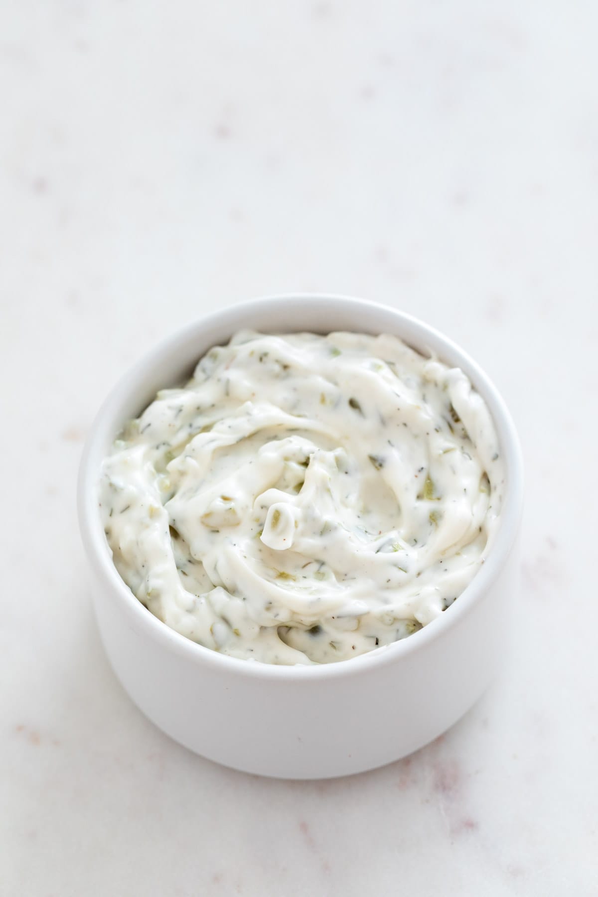 Small bowl with vegan tartar sauce.