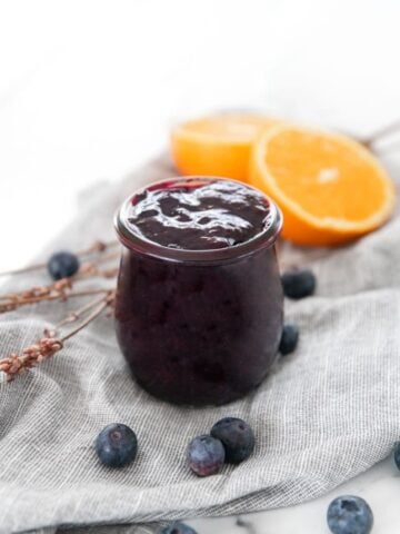 Photo of a little glass jar of blueberry compote
