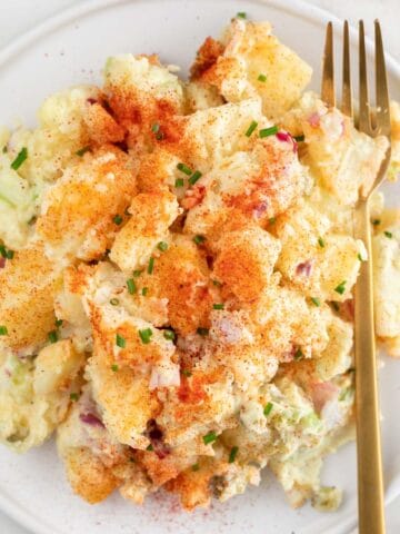 Vegan potato salad on a plate with a fork.
