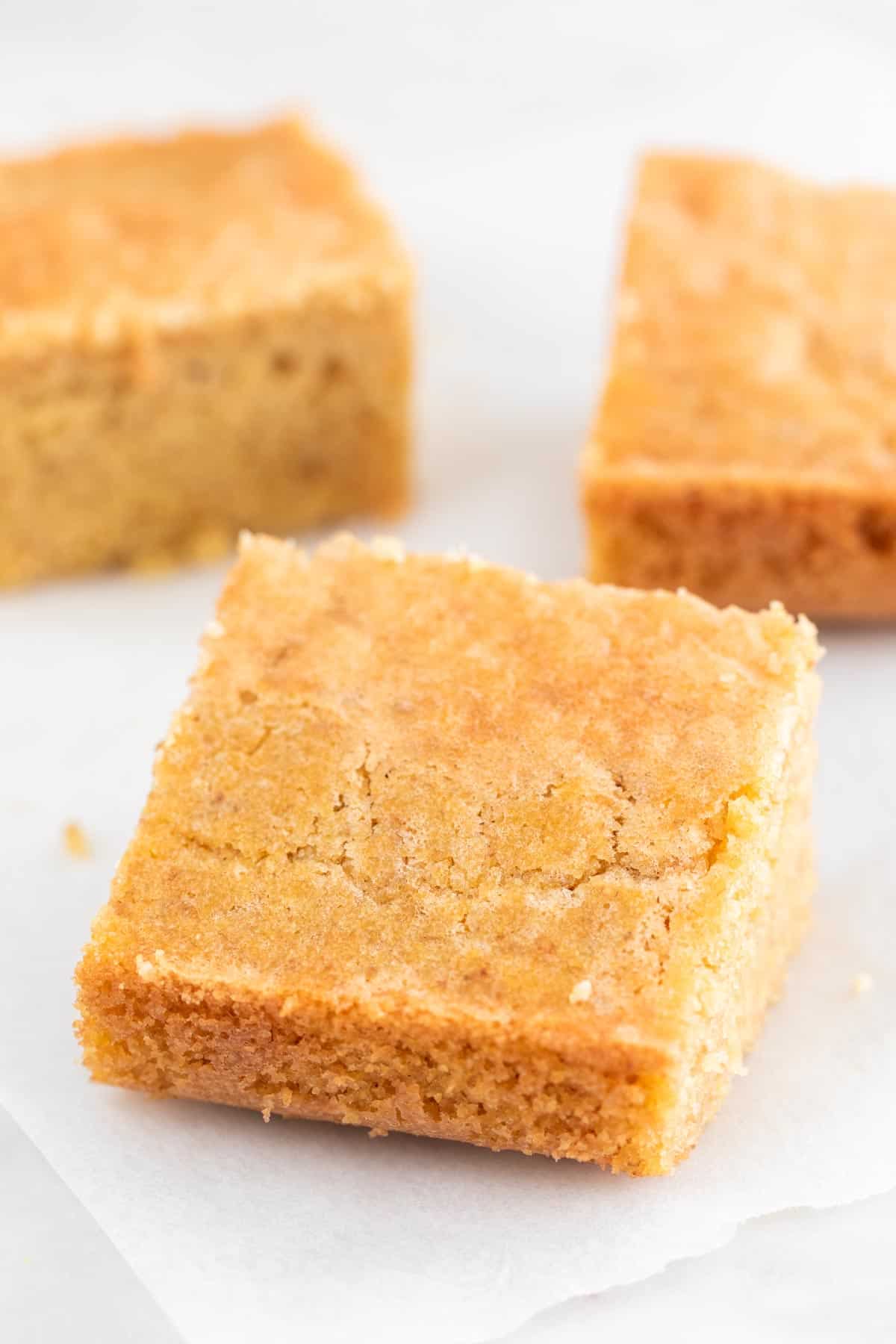 Cornbread squares onto a white board.