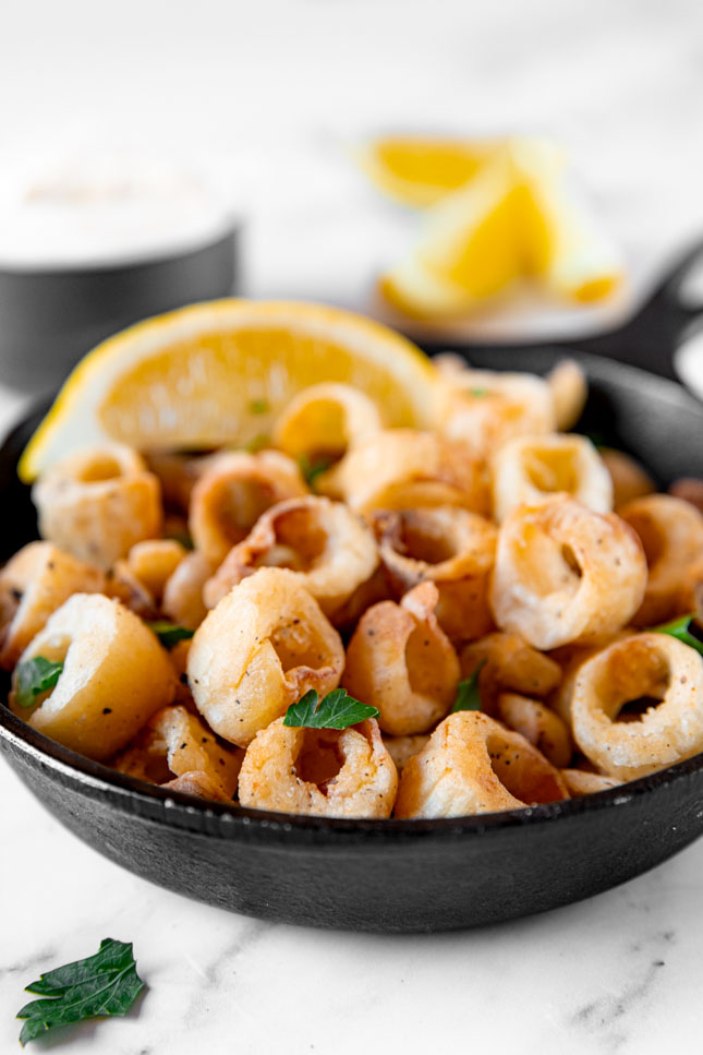 Side shot of a bowl of hearts of palm calamari