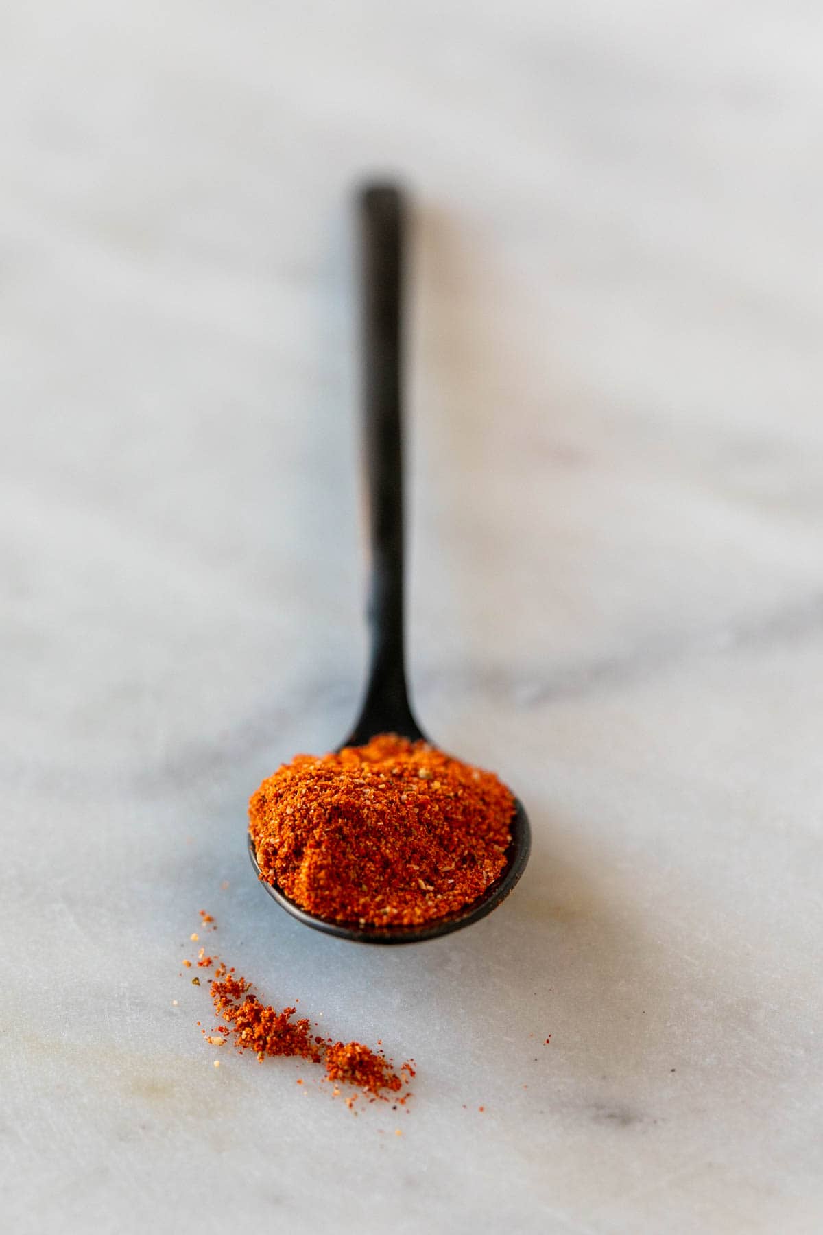 Black teaspoon with homemade chili powder.