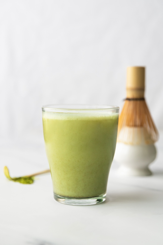 Side shot of a cup of matcha latte