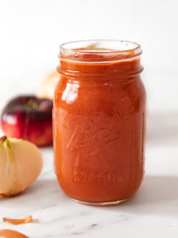 Side shot of a glass jar of homemade pizza sauce