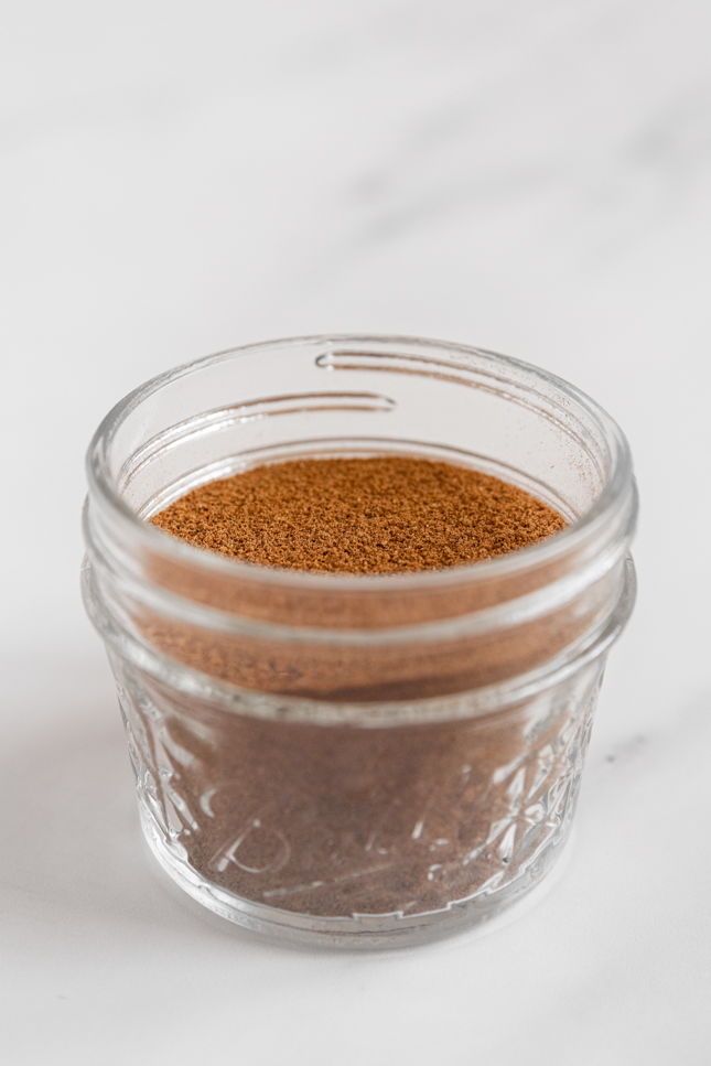 Side shot of a glass jar of pumpkin pie spice