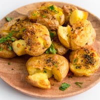 Square photo of a plate of smashed potatoes