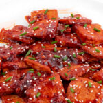 Close-up photo of a plate of spicy tofu with a title