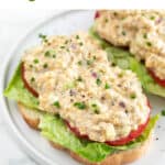 Open sandwich with lettuce, tomato slices and vegan chicken salad.