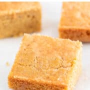 Cornbread squares arranged on a white board.