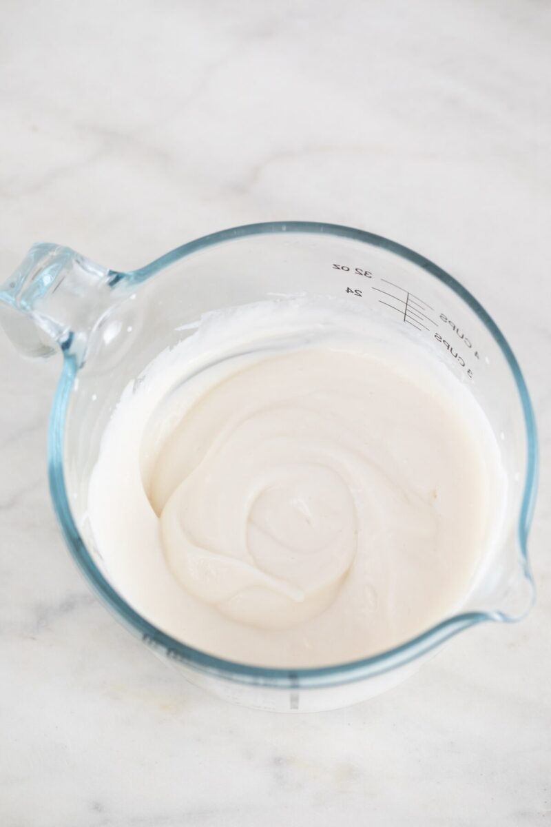 Photo of a measuring cup with homemade vegan aioli.