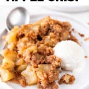 Plate of vegan apple crisp with vegan vanilla ice cream and a spoon.