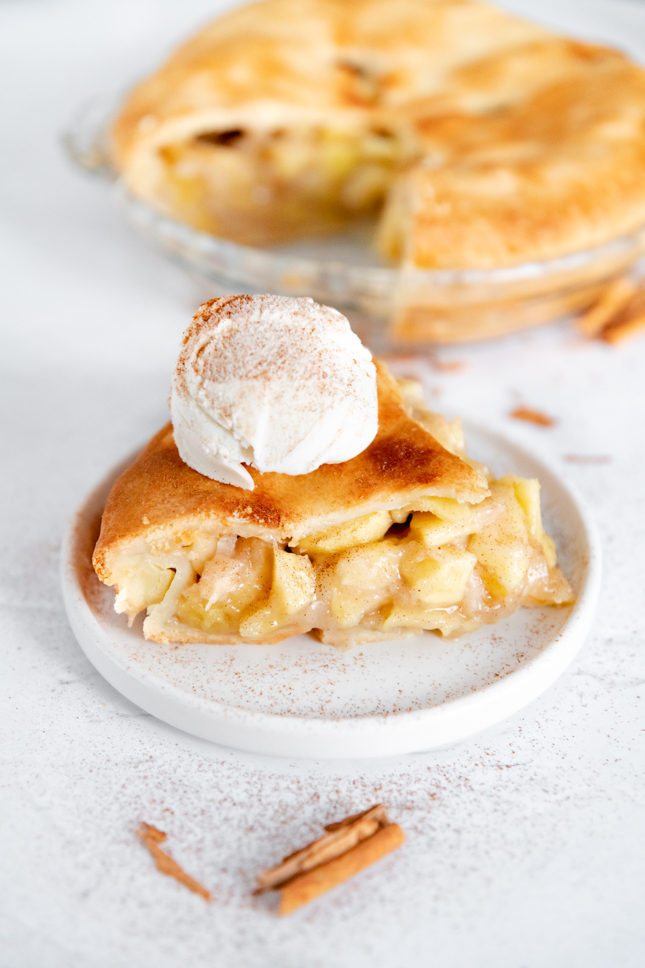 Photo of a slice of vegan apple pie with some ice cream