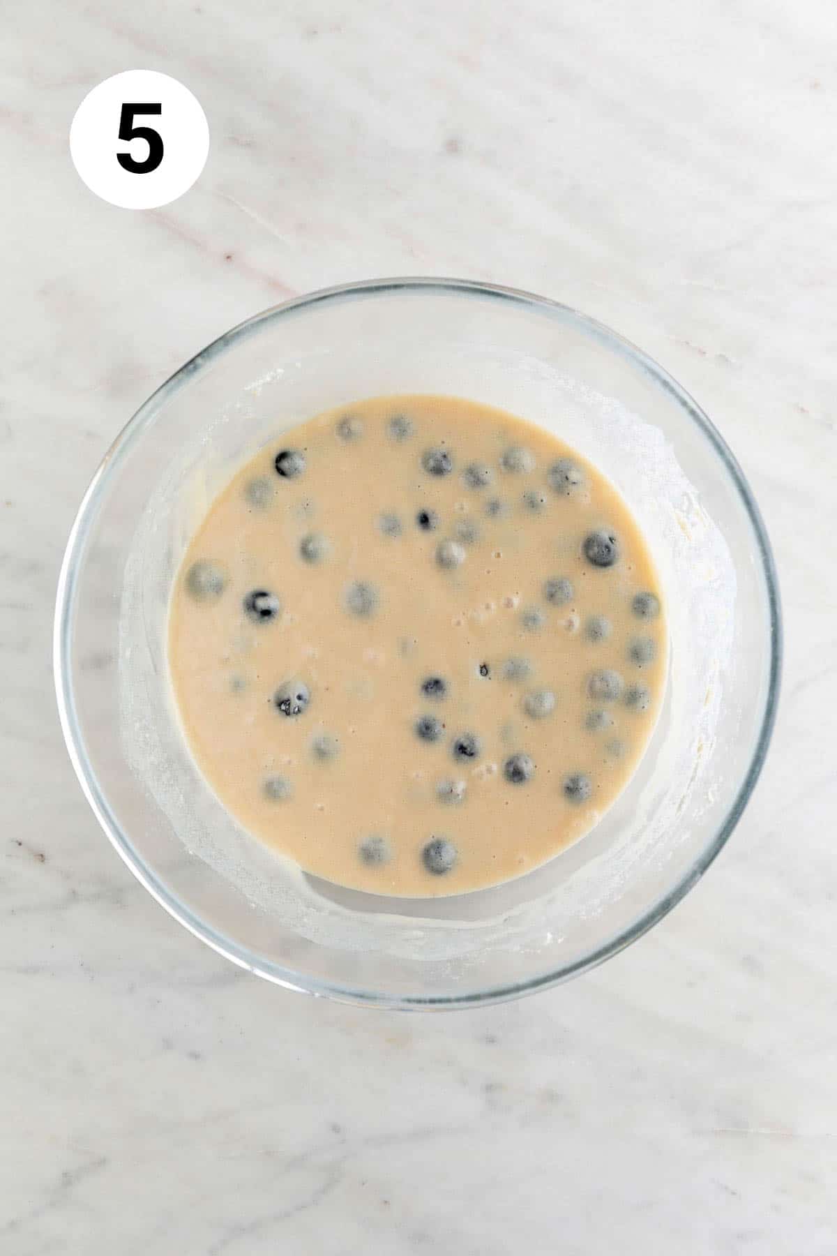 Vegan blueberry muffin batter in a large mixing bowl.