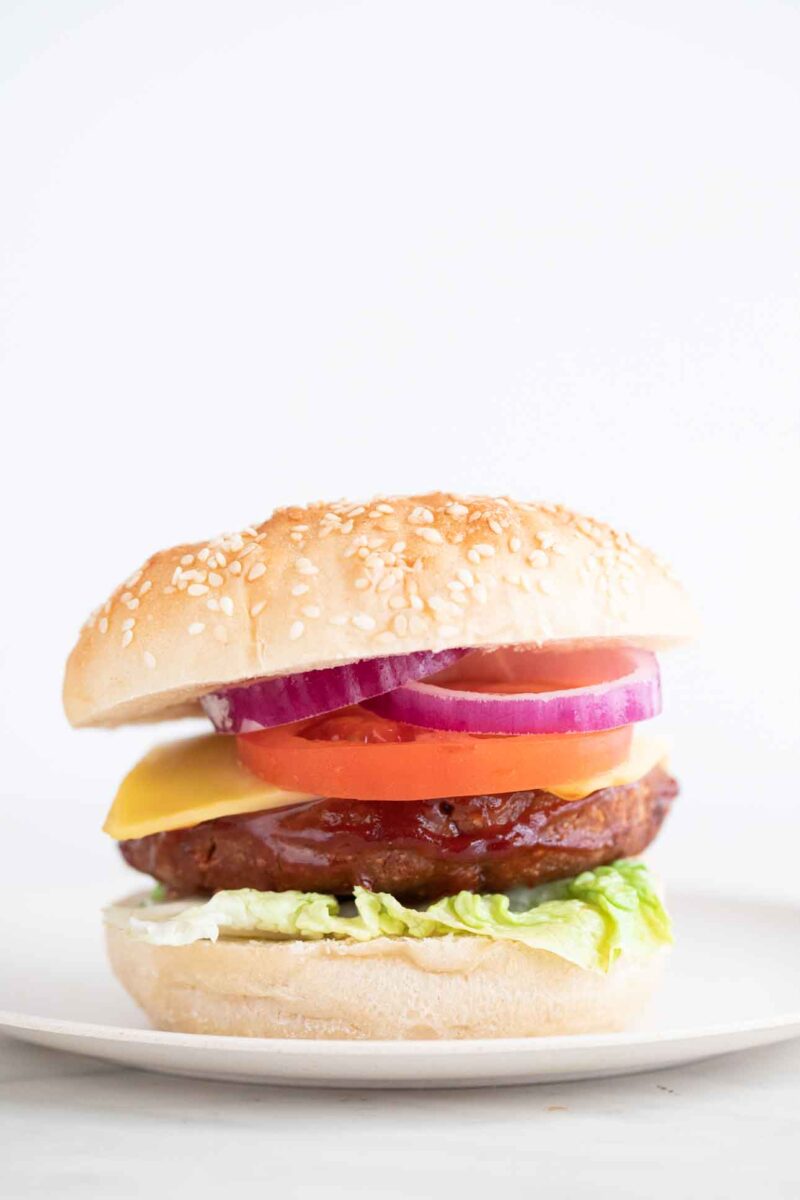A side shot of a dish with a homemade vegan burger