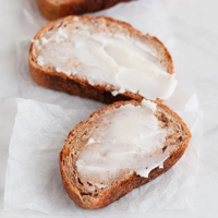 Square photo of some vegan butter spread onto some slices of bread
