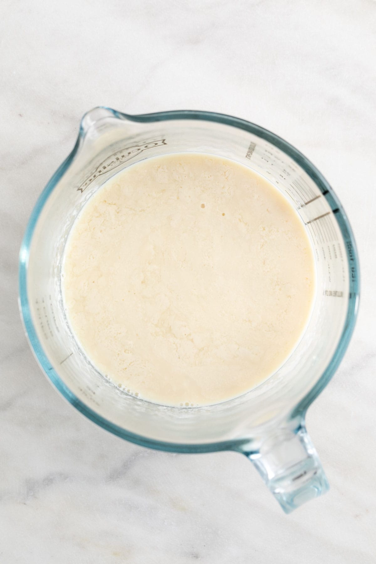 Vegan buttermilk in a measuring cup.