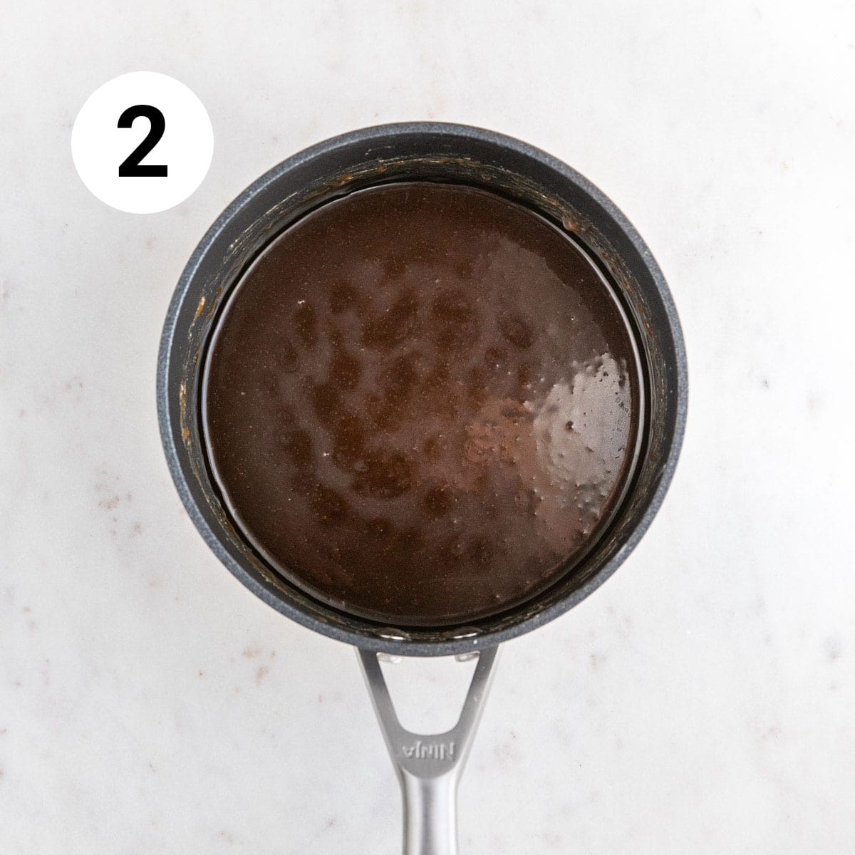 Saucepan with cooked vegan caramel sauce.