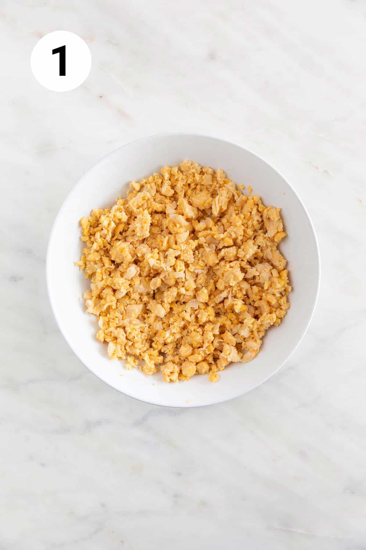 Mashed chickpeas in a shallow dish.