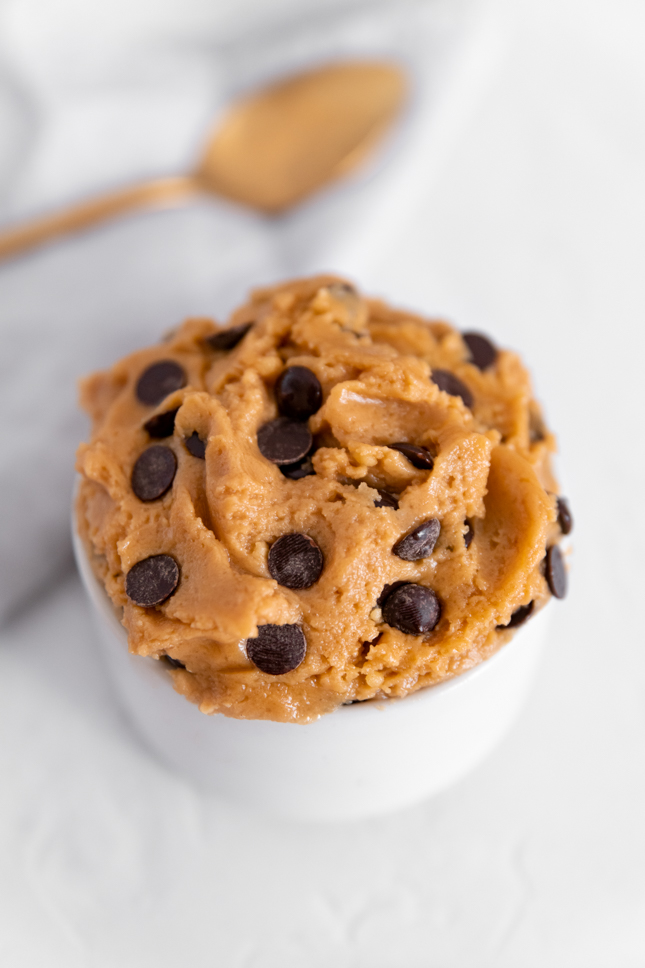 Photo of a spoon and a bowl of vegan cookie dough