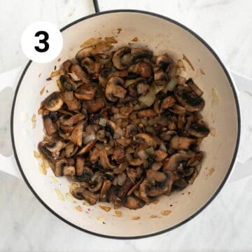 Mushrooms, garlic and onion sautéed in a large pot.