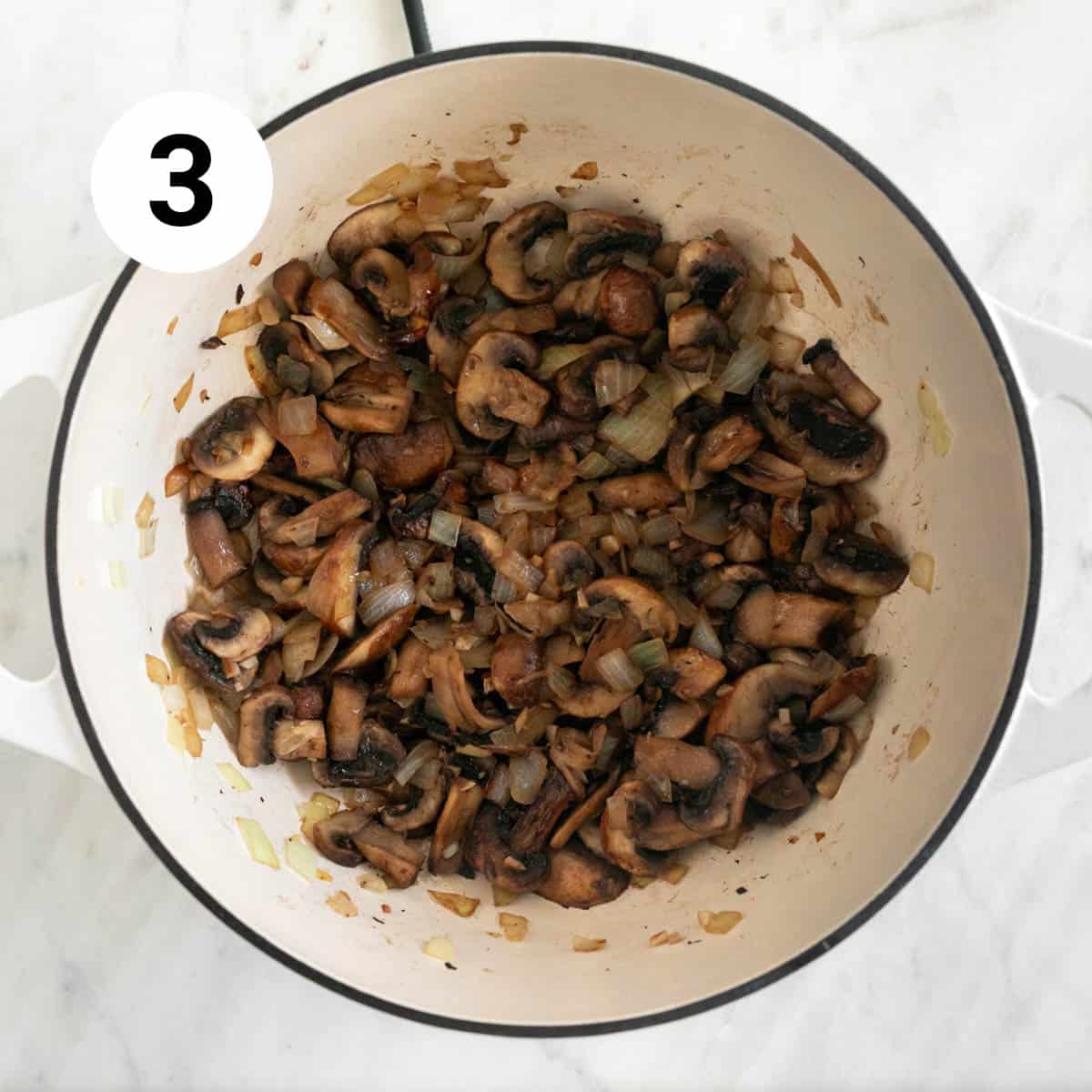 Mushrooms, garlic and onion sautéed in a large pot.