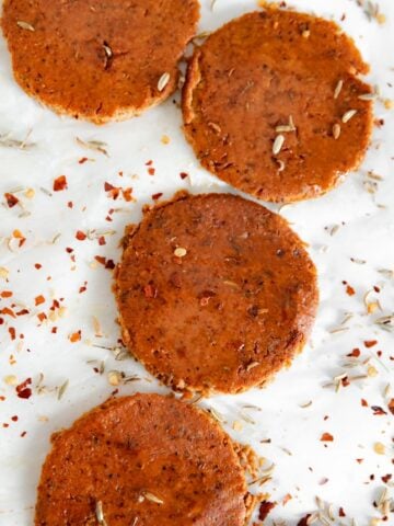 Photo of a plate with some slices of vegan pepperoni