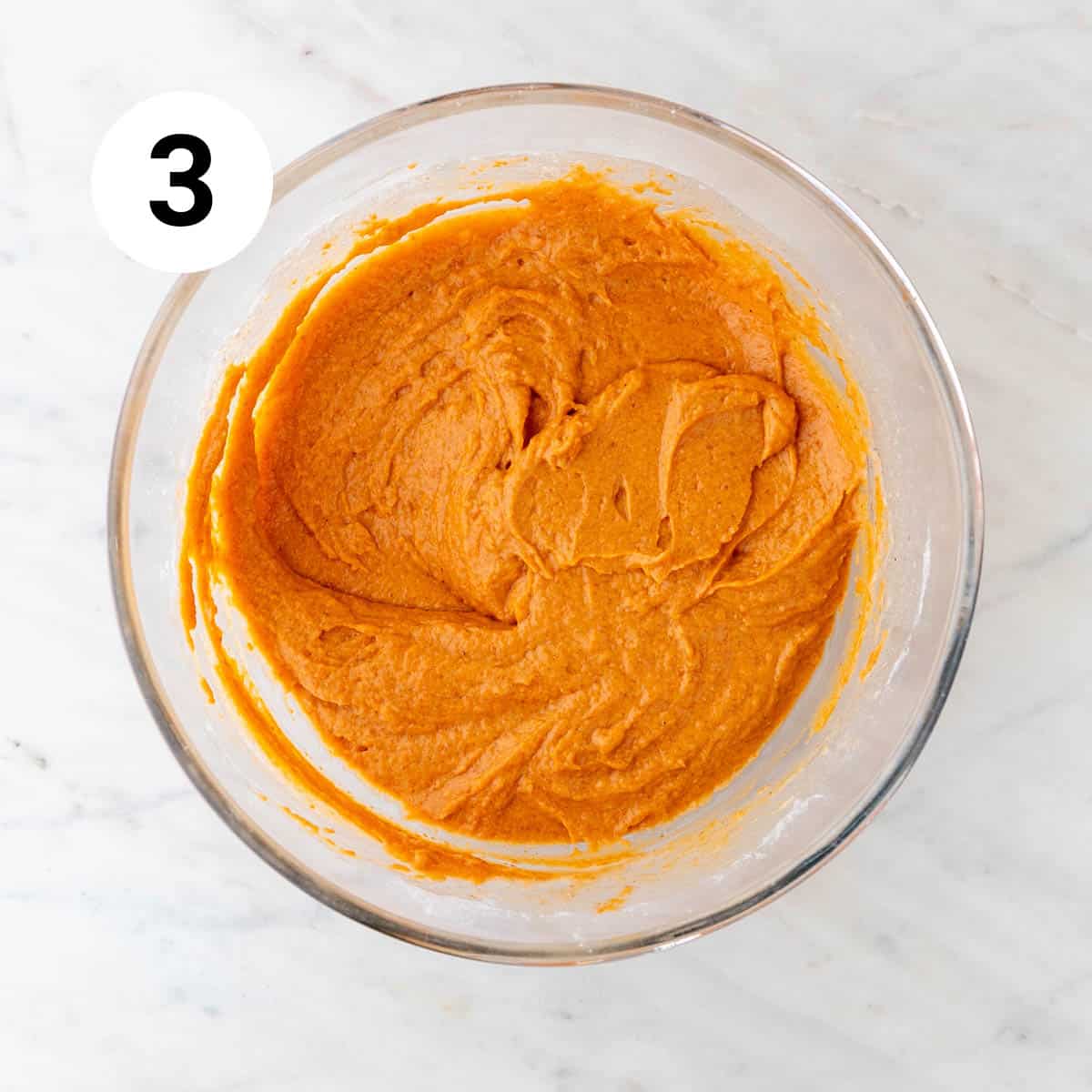 Vegan pumpkin muffin batter in a large mixing bowl.