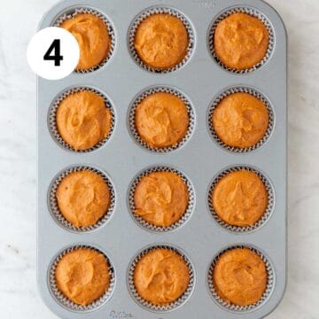 Muffin pan with liners filled with vegan pumpkin muffin batter.