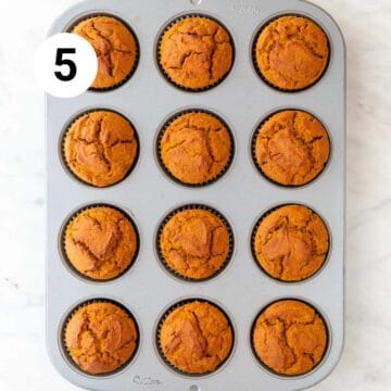 Baked vegan pumpkin muffins in a muffin pan.