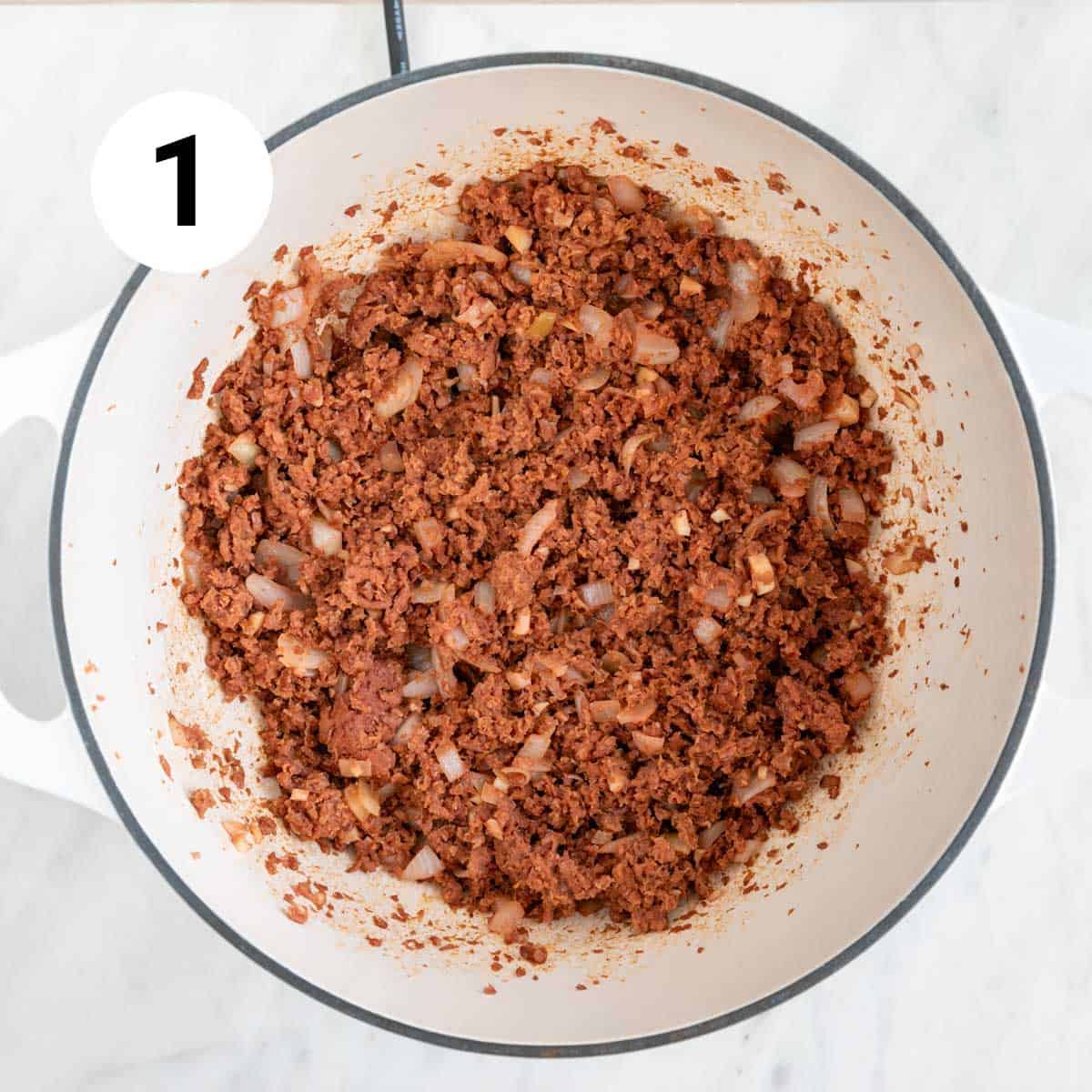 Cooked onion, garlic, and vegan ground beef in a large pot.