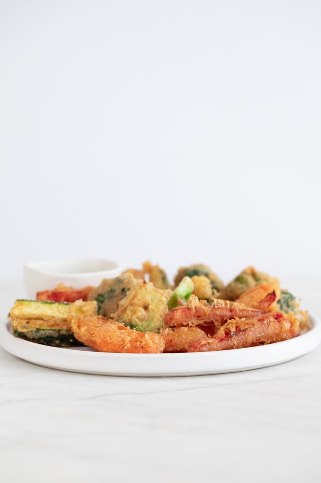 A side shot of a dish with vegetable tempura